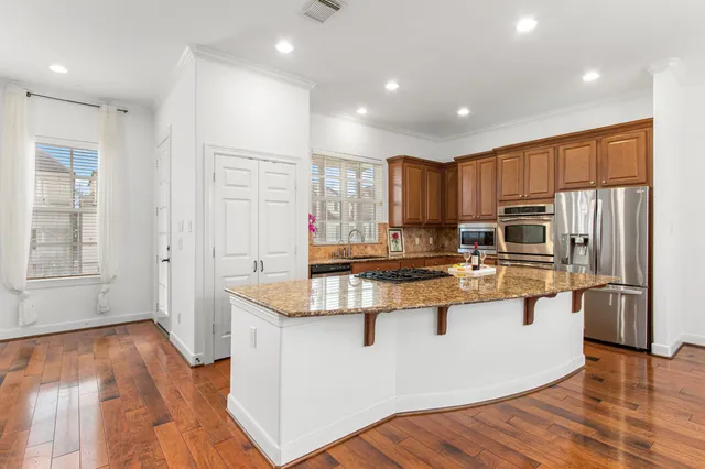 a kitchen with stainless steel appliances granite countertop a stove and a sink