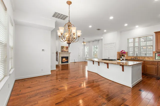 a view of a room with wooden floor and fan