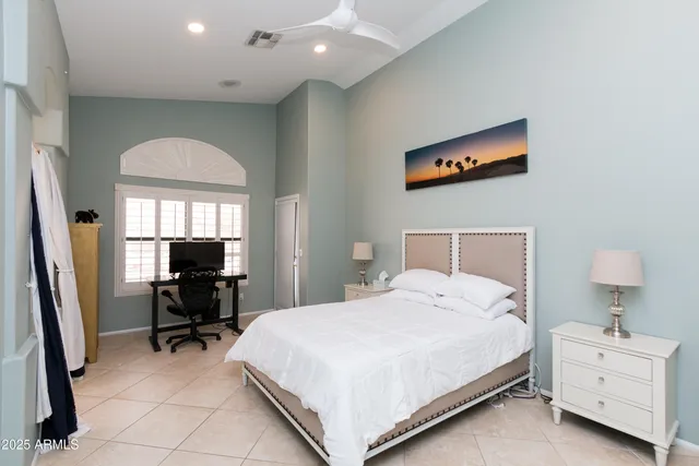 a bed room with a bed and a chair