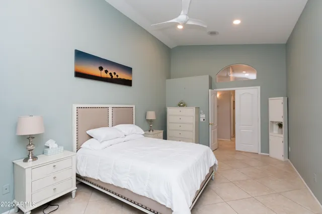 a bedroom with a bed and a lamp on table