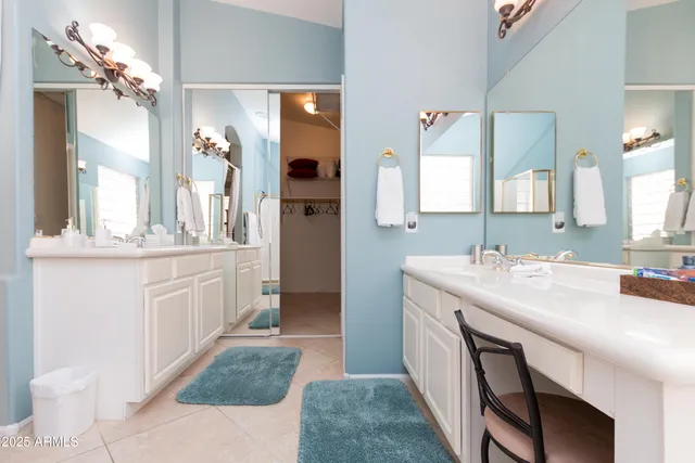 a bathroom with a sink a vanity and a mirror