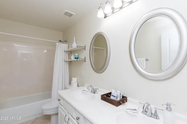 a bathroom with a toilet a sink a mirror and bathtub