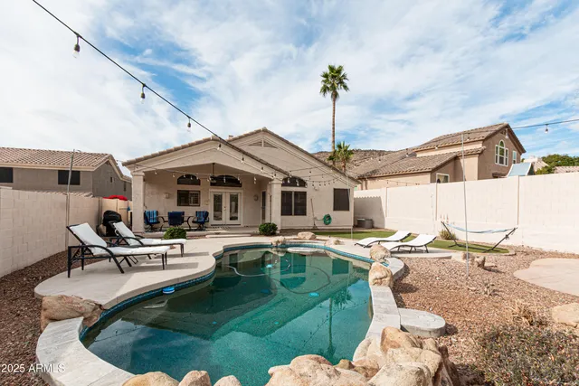 a roof deck with table and chairs