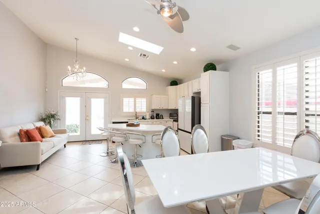 a view of a dining room with furniture and a chandelier