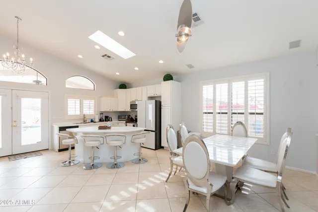 a dining room with furniture and a large window