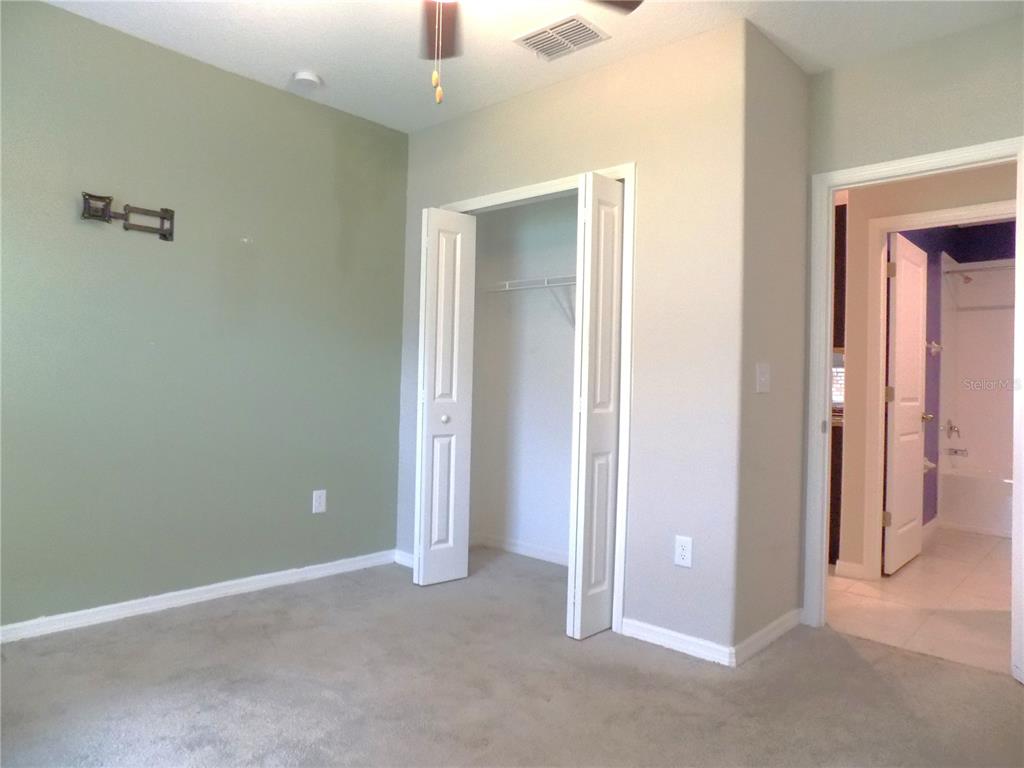 9411 Lemon Drop Loop Sun City Center, FL 33573 - Photo 15 of 47 an empty room with closet and a bathroom view