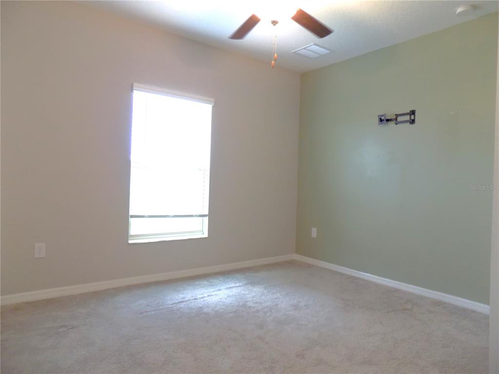 9411 Lemon Drop Loop Sun City Center, FL 33573 - Photo 16 of 47 an empty room with a window