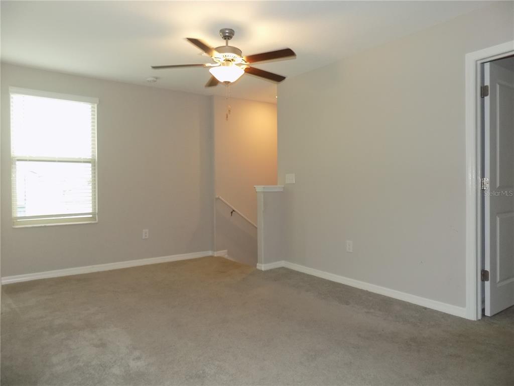 9411 Lemon Drop Loop Sun City Center, FL 33573 - Photo 22 of 47 an empty room with a window