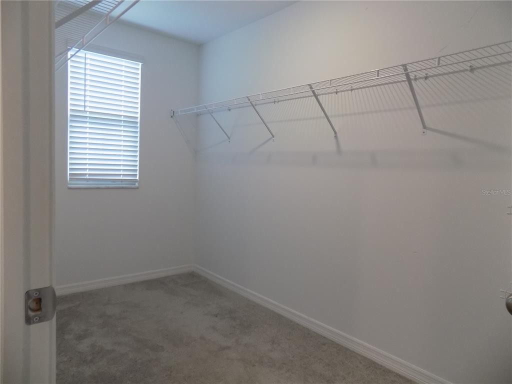 9411 Lemon Drop Loop Sun City Center, FL 33573 - Photo 28 of 47 a view of a room with racks on the wall