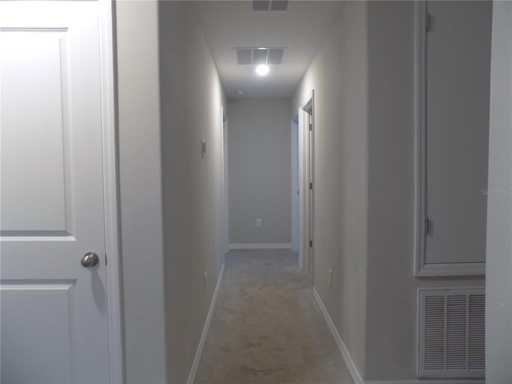 9411 Lemon Drop Loop Sun City Center, FL 33573 - Photo 32 of 47 a view of a hallway