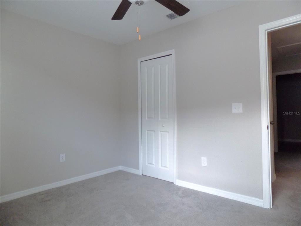 9411 Lemon Drop Loop Sun City Center, FL 33573 - Photo 35 of 47 an empty room with a empty space and a window