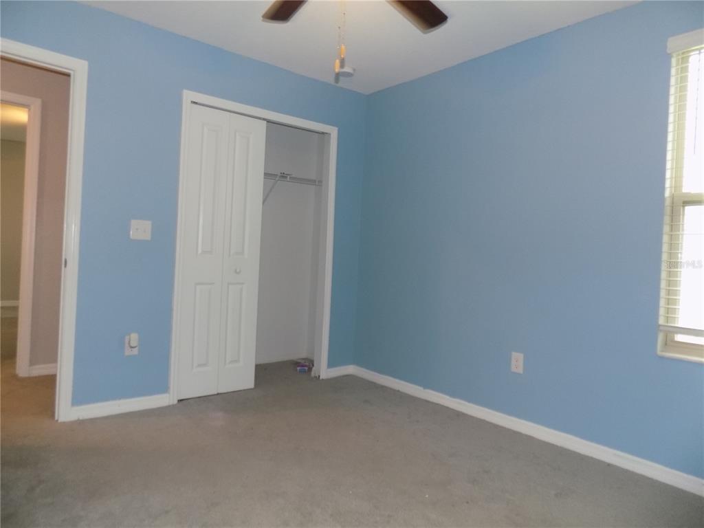 9411 Lemon Drop Loop Sun City Center, FL 33573 - Photo 39 of 47 an empty room with windows and closet