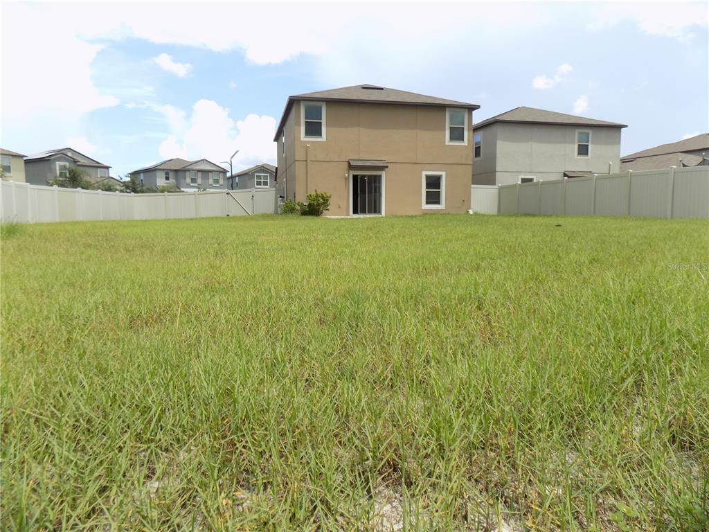 9411 Lemon Drop Loop Sun City Center, FL 33573 - Photo 42 of 47 a house view with a garden space