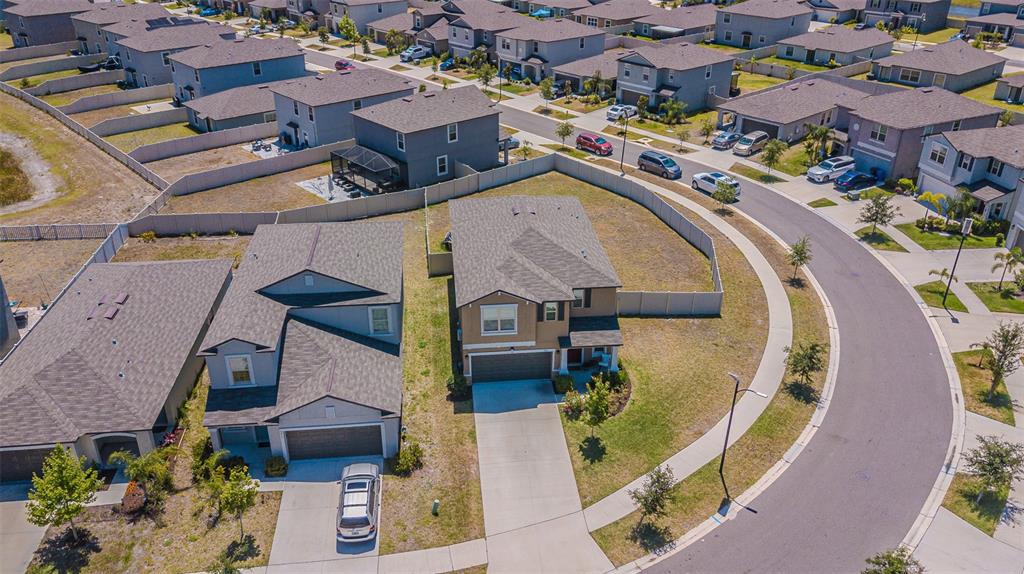 9411 Lemon Drop Loop Sun City Center, FL 33573 - Photo 43 of 47 an aerial view of a house with a swimming pool yard and outdoor seating