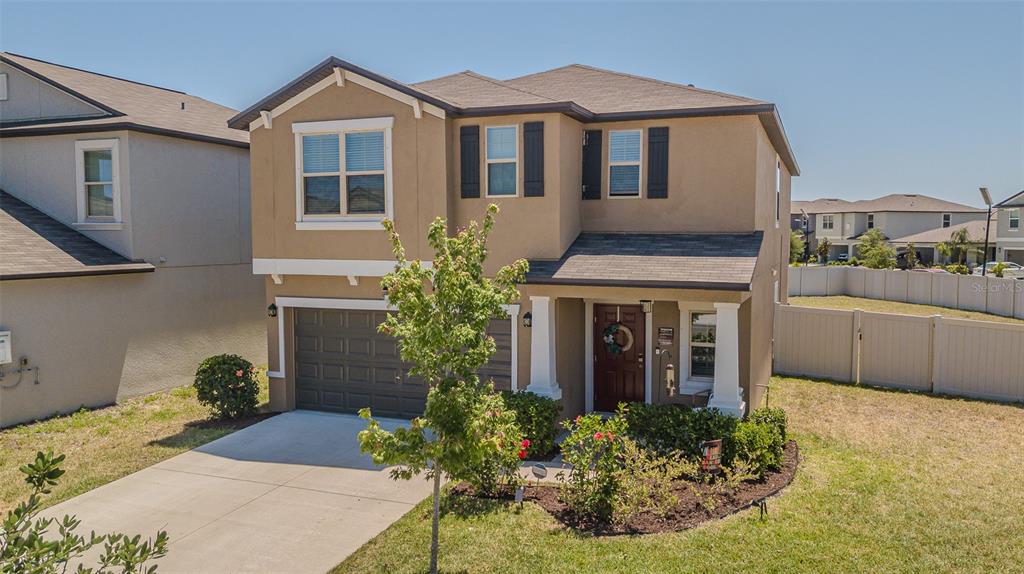 9411 Lemon Drop Loop Sun City Center, FL 33573 - Photo 47 of 47 a front view of a house with garden
