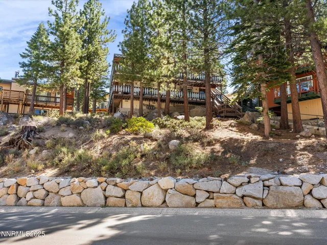 a view of a yard with wooden fence