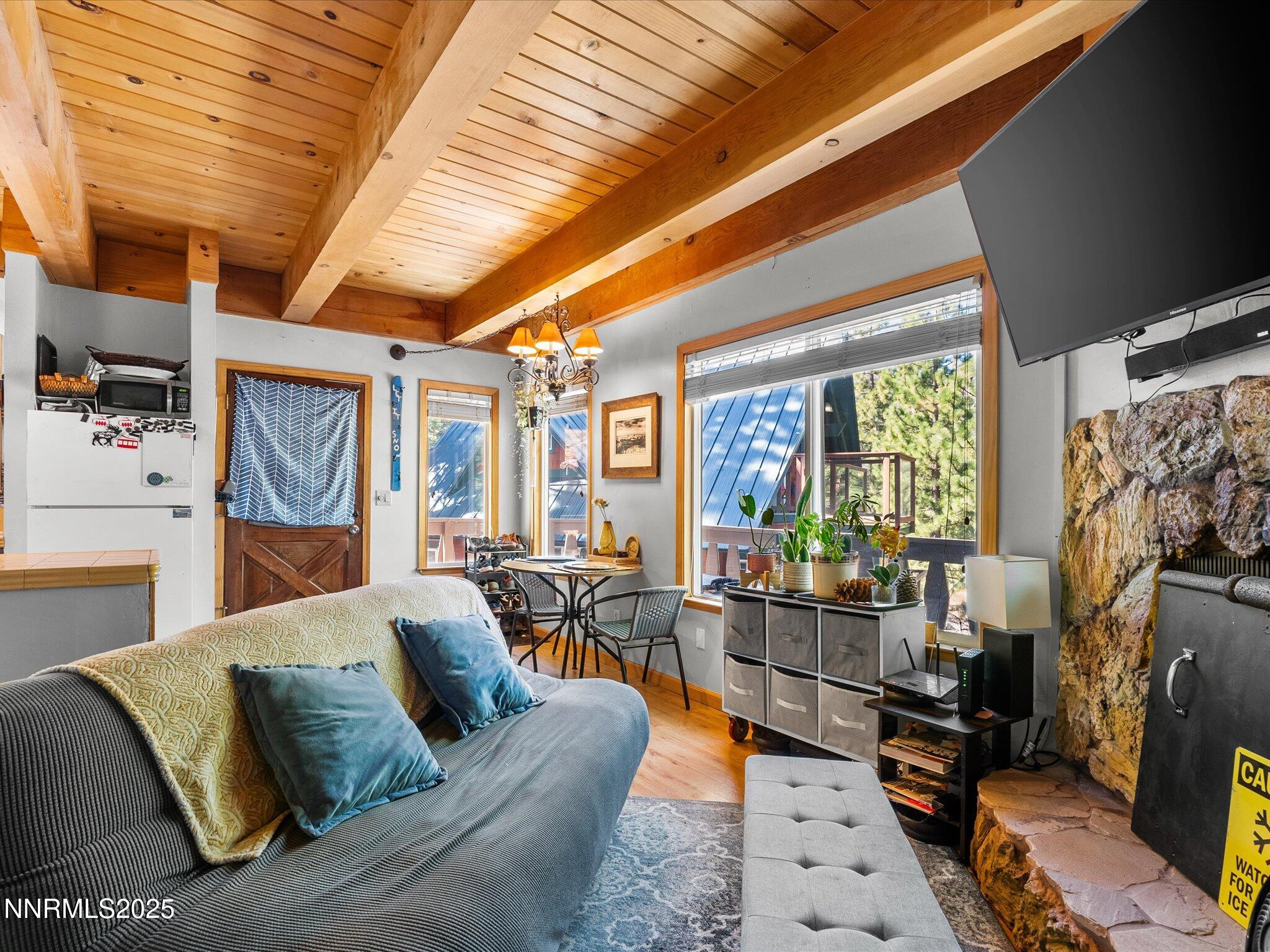 259 Tramway Drive, Unit 4 Stateline, NV 89449 - Photo 13 of 33 a living room with furniture a flat screen tv and a large window