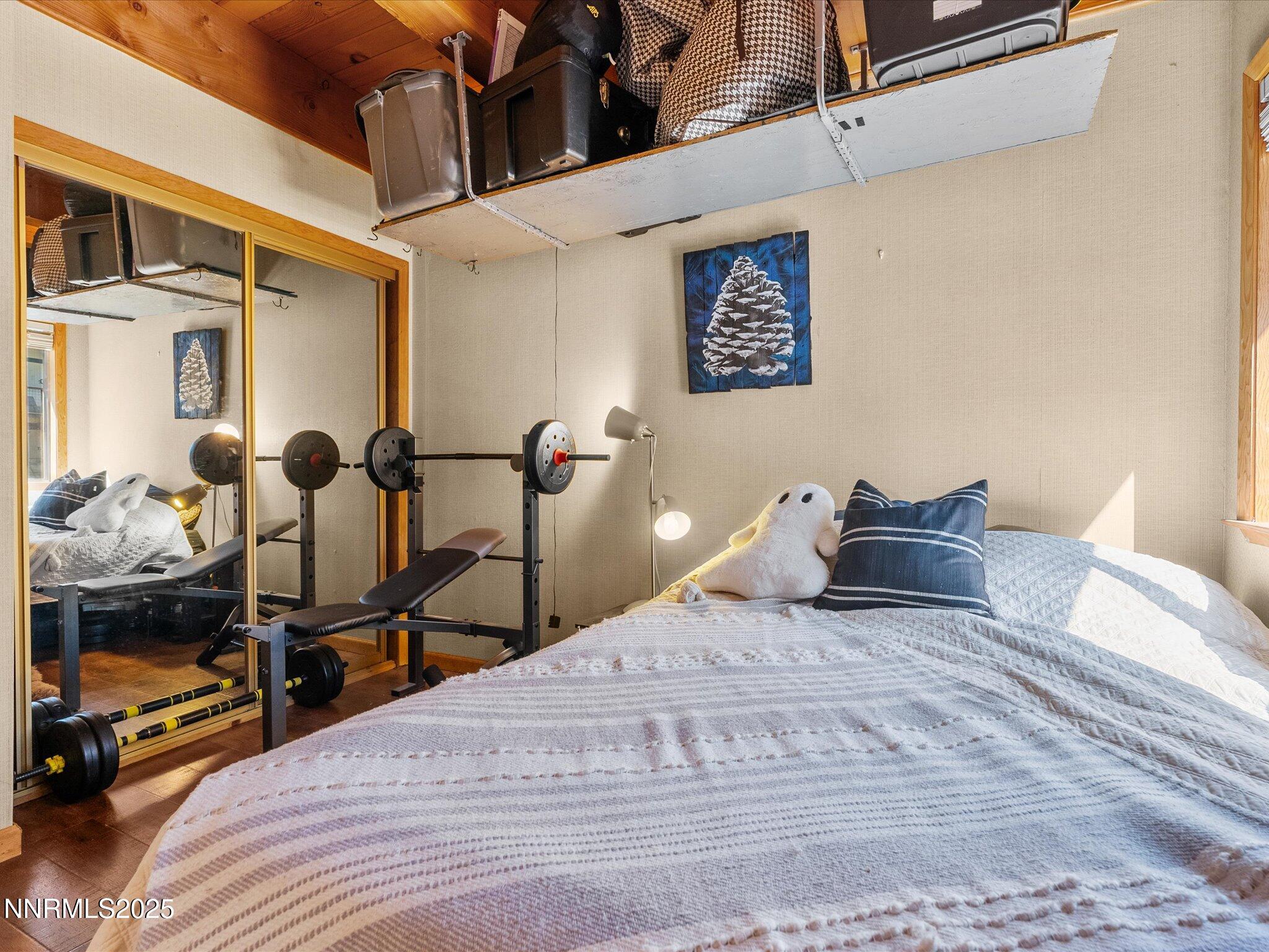 259 Tramway Drive, Unit 4 Stateline, NV 89449 - Photo 15 of 33 a bedroom with a bed and wooden floor