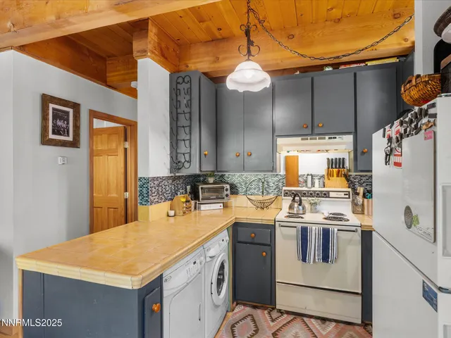 a kitchen with a sink a stove and cabinets