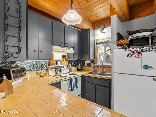 a kitchen with stainless steel appliances a sink stove and refrigerator