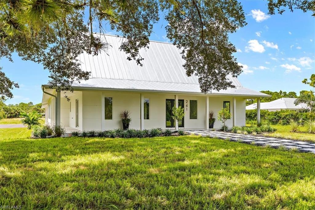 261 13th Street Southwest Naples, FL 34117 - Photo 1 of 35 Country-style home with a front lawn