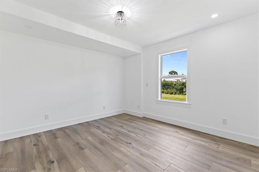 261 13th Street Southwest Naples, FL 34117 - Photo 11 of 35 Spare room with light wood-type flooring