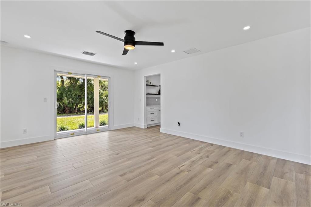 261 13th Street Southwest Naples, FL 34117 - Photo 15 of 35 Empty room with light wood-type flooring and ceiling fan