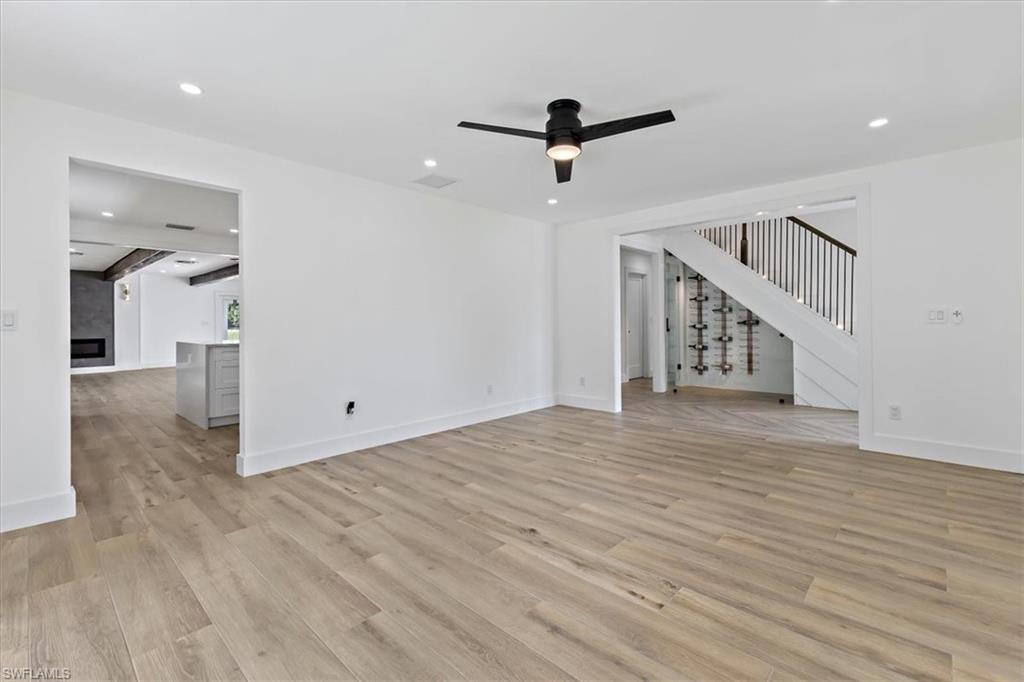 261 13th Street Southwest Naples, FL 34117 - Photo 16 of 35 Unfurnished living room with ceiling fan and light hardwood / wood-style floors
