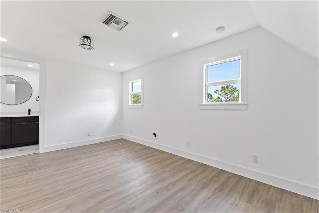 261 13th Street Southwest Naples, FL 34117 - Photo 27 of 35 Unfurnished living room featuring lofted ceiling and light hardwood / wood-style floors