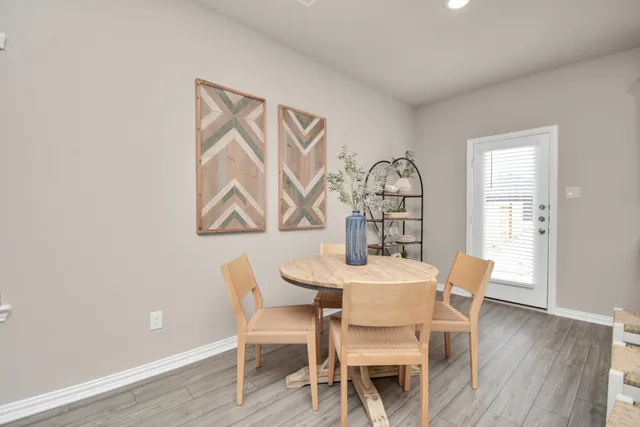 a bedroom with bed and wooden floor