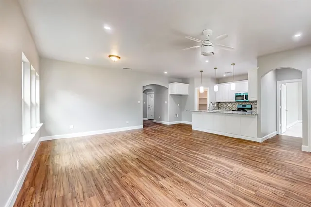 a view of a kitchen with a sink and wooden floor