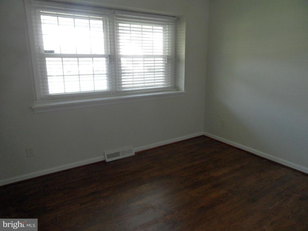 1405 Clearview Road Edgewood, MD 21040 - Photo 10 of 23 an empty room with wooden floor and windows
