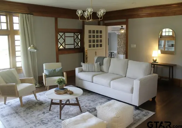 a living room with furniture and a chandelier