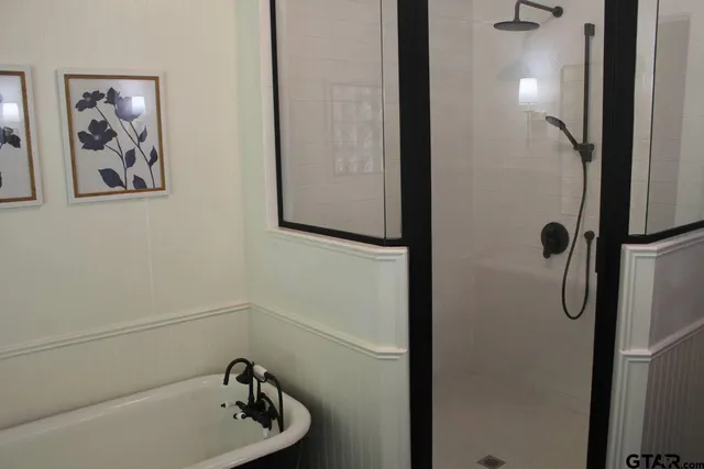 a bathroom with a tub and shower