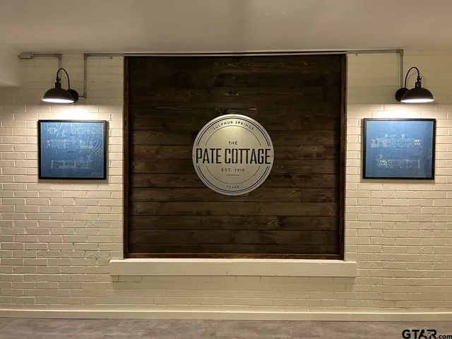 a front view of a house with a yard and potted plants