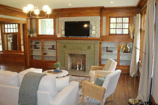a living room with furniture a flat screen tv and a fireplace