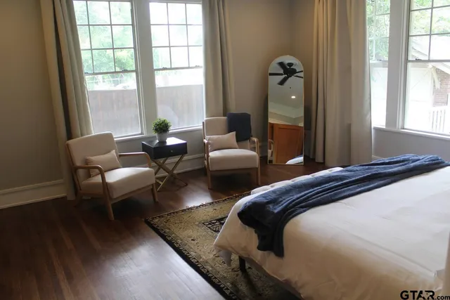 a bedroom with two beds and a large window