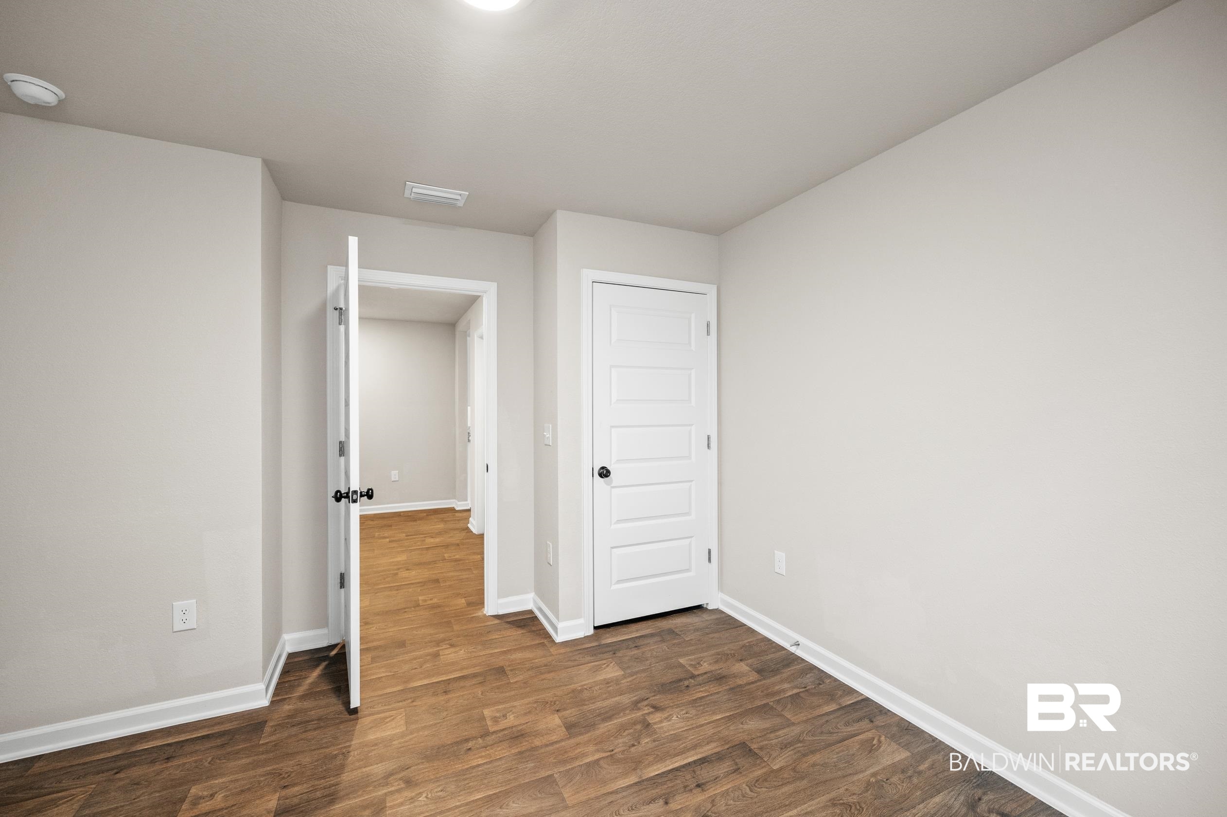 10353 Zenyatta Loop Daphne, AL 36526 - Photo 28 of 33 Unfurnished bedroom with dark hardwood / wood-style floors
