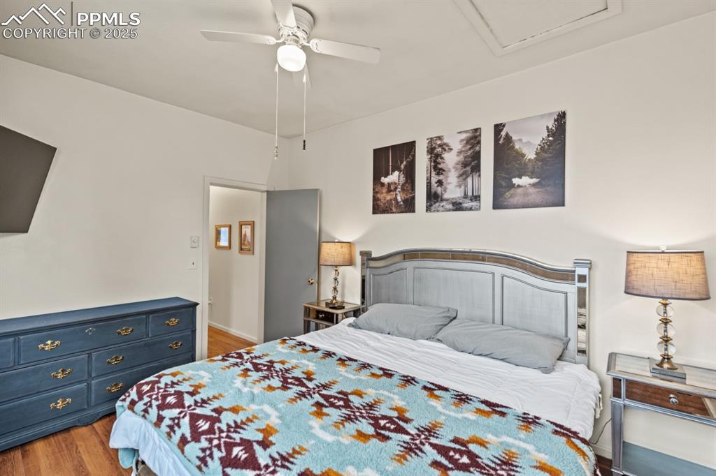 315 5th Street Victor, CO 80860 - Photo 9 of 15 a bedroom with a large bed and a lamp on dresser