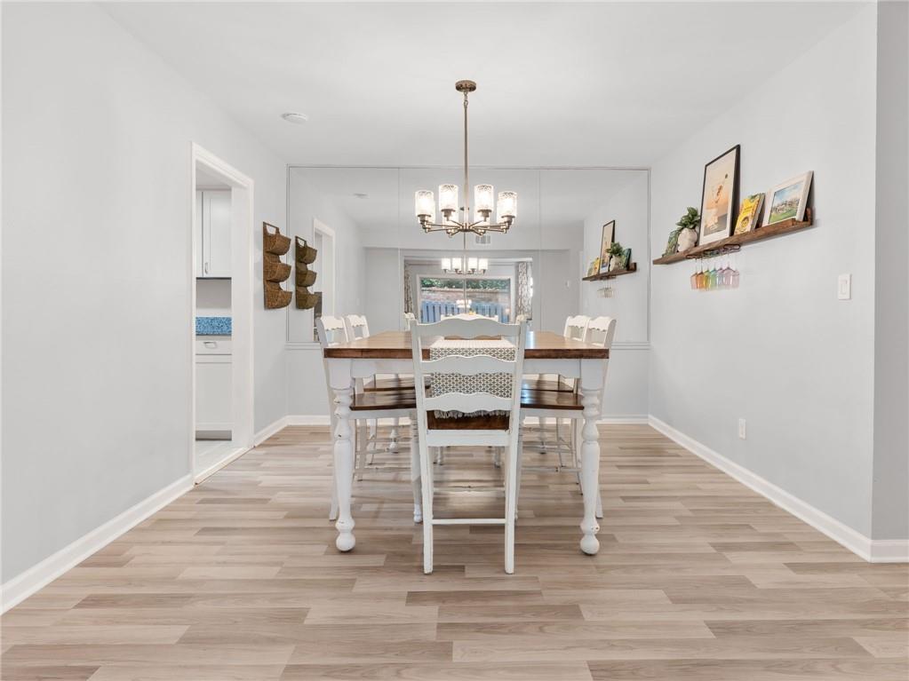 6851 Roswell Road, Unit H26 Atlanta, GA 30328 - Photo 7 of 49 a view of a dining room with furniture and wooden floor