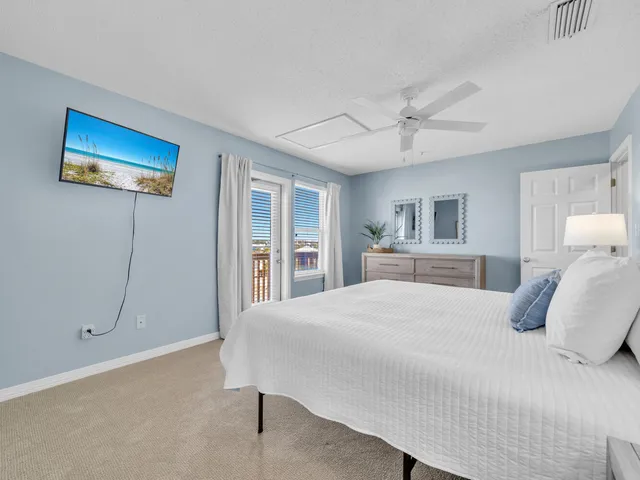 a bedroom with a large bed and a window