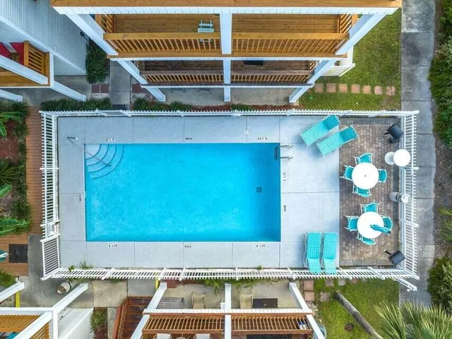 a view of a swimming pool with outdoor seating