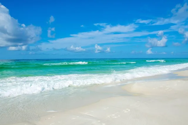 a patio with a table and chairs under an umbrella