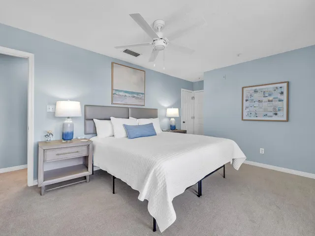 a bed room with a bed and a ceiling fan