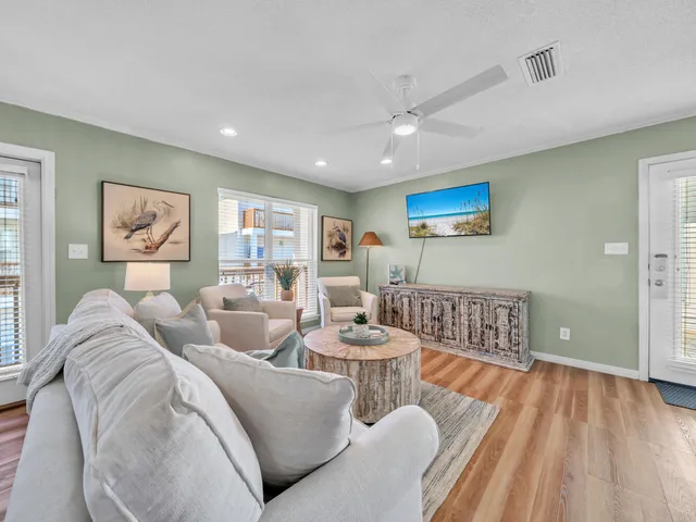 a living room with furniture and a refrigerator