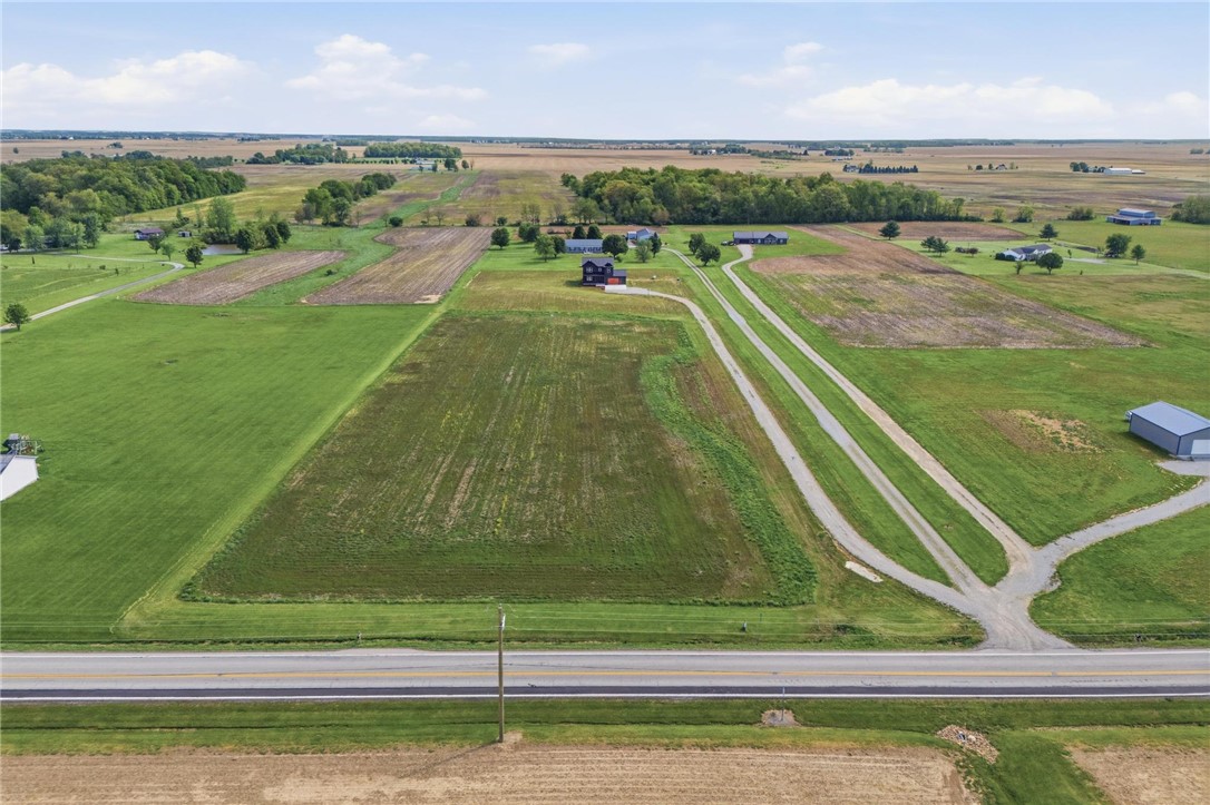 3509 South State Rte 72 Sabina, OH 45169 - Photo 39 of 44 Vast green acreage with a clear roadway, offering expansive views and rural tranquility.