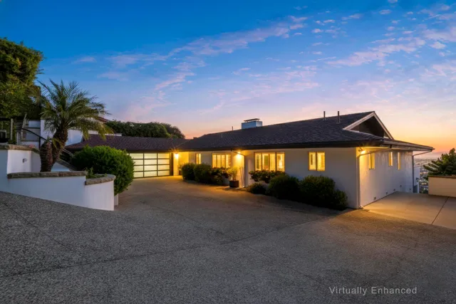 a view of a house with a yard and garage