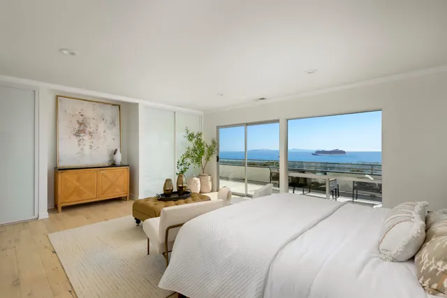 a bedroom with a bed a couch and dresser