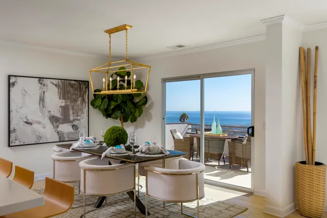 a living room with furniture a rug and a chandelier