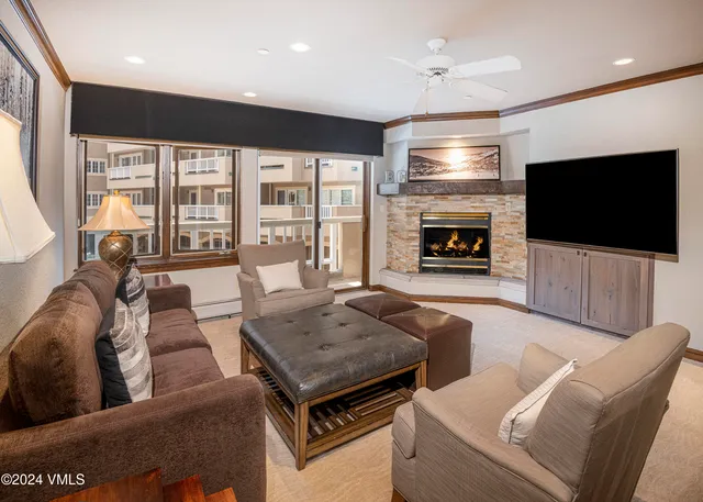 a living room with fireplace furniture and a flat screen tv